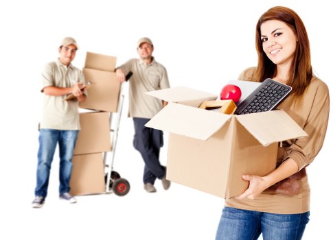A moving team preparing boxes and furniture for transport in Finland